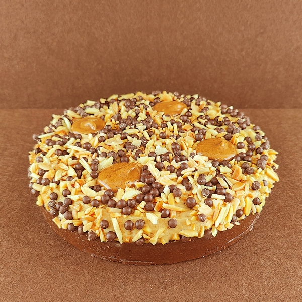 Tarta Ópera cuadrada para varias personas, fotografiada en ángulo de 45 grados, con cobertura de chocolate, cortes limpios donde se aprecian todas las capas y granos de café decorativos en la superficie.